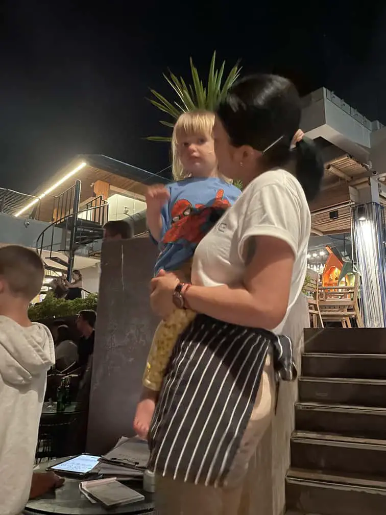 Kind waitress holding our 2-year-old during the fireshow